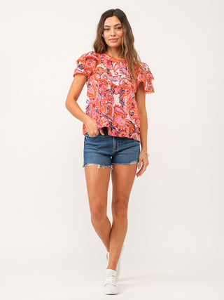 playful paisley print blouse in red and orange with lacey details and ruffled short sleeves worn with jean shorts