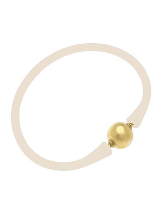 a white silicone stackable bali bracelet with gold plated bead clasp