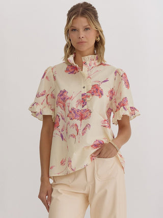 a cream top with pink floral print and charming ruffles