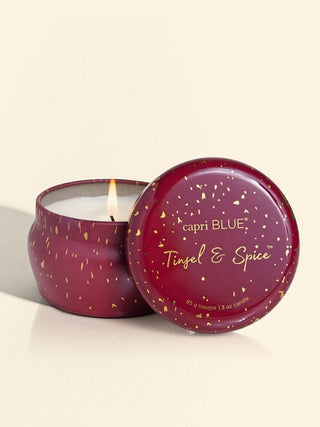 a beautiful ruby red and gold mini tin holiday candle in the tinsel and spice scent