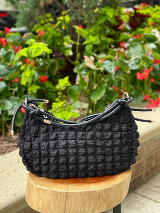 black quilted crossbody purse with knotted strap and metal detail