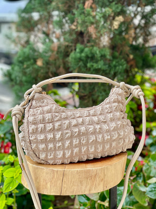 Taupe quilted crossbody purse with knotted strap and metal detail