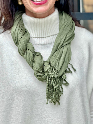 a lightweight olive green crinkle scarf with a fringe hem