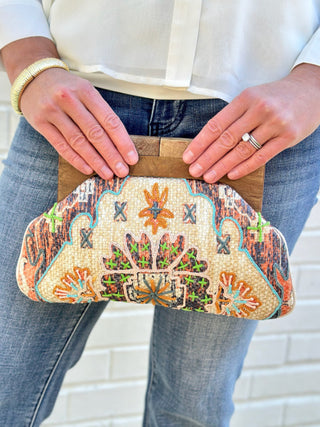 a trendy cream tapestry design clutch bag