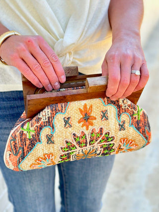 a trendy cream tapestry design clutch bag