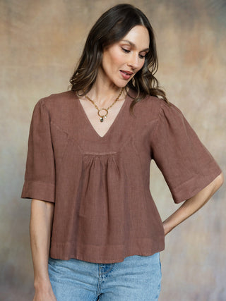 brown wide neck short sleeve blouse with cinching detail in the front 