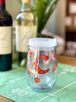 a clear hard plastic drink tumbler with an orange clemson c and tiger prints