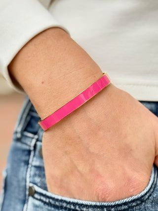 a pink and gold bangle bracelet