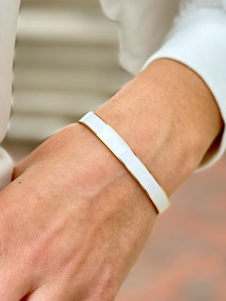 a white and gold bangle bracelet