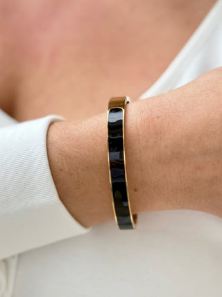 a black and gold bangle bracelet