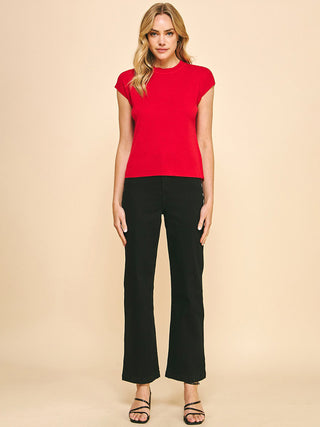 a red lightweight cap sleeve sweater top essential worn with black pants