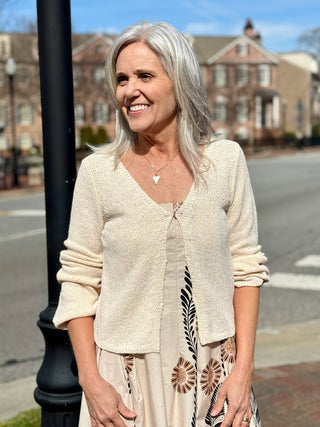 a soft ivory cream cropped knit cardigan with front hooks