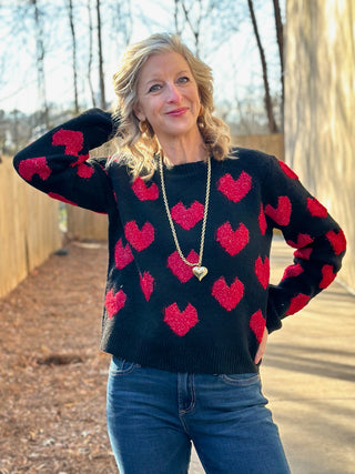 a cozy black sweater with flirty red valentine hearts