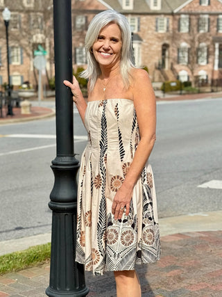 a charming beige strapless midi dress with a black and brown floral print