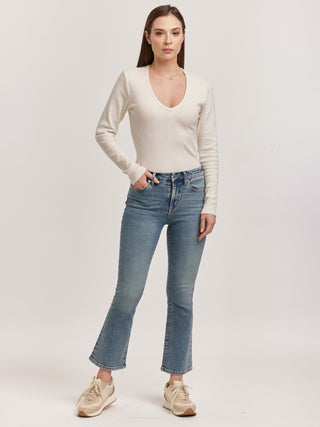 antique washed high rise jeans with a cropped clean hem worn with a white top