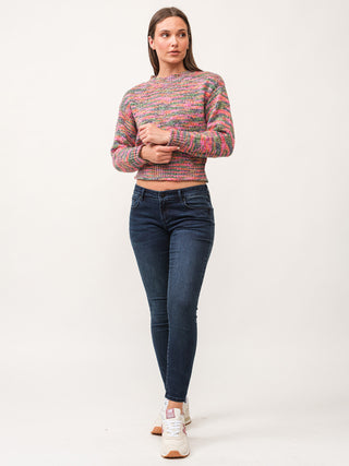 a fun and colorful long sleeve cropped yarn sweater with shimmer worn with jeans