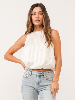 elegant ivory halter blouson top with an elastic waist and cinched silhouette