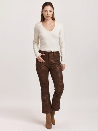 shimmering brown high rise cropped flare pants with a metallic printed faux leather fabric worn with a white long sleeve shirt