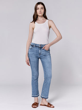 a pair of light wash denim mid rise jeans with a cropped straight leg and raw hem worn with a white top