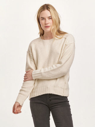 long sleeve cream knit sweater with drop shoulders and exposed seams