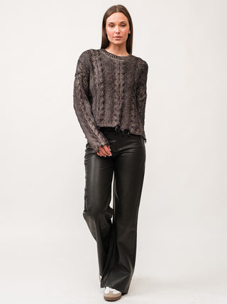 edgy gunmetal cable knit long sleeve sweater with frayed edges worn with faux leather black pants