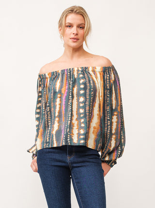 a multi colored abstract long sleeve blouse with an off the shoulder cut