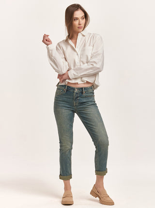 a chic white long sleeve button up cropped top with a crisp collar worn with washed jeans