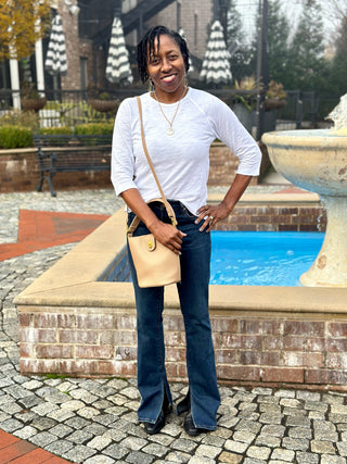 a basic white crew neck shirt with three quarter sleeves worn with dark denim jeans