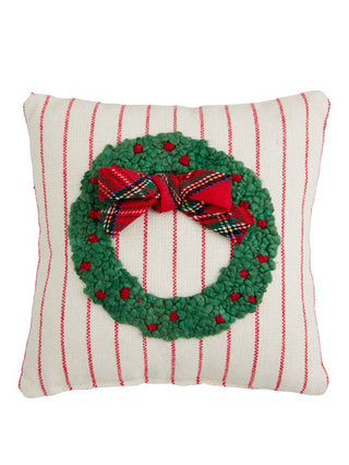 a mini holiday decorative pillow with an embroidered wreath image