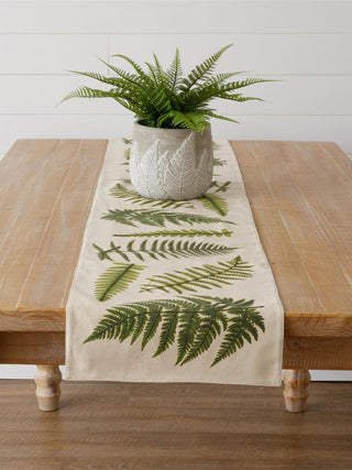 a cream table runner with a fresh green fern pattern