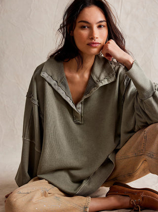 free people green oversized henley sweatshirt with a collared neckline and snap button closures with shoulder sleeves