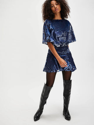 a soft velvet navy mini dress with a drop waist silhouette and flowy bottom