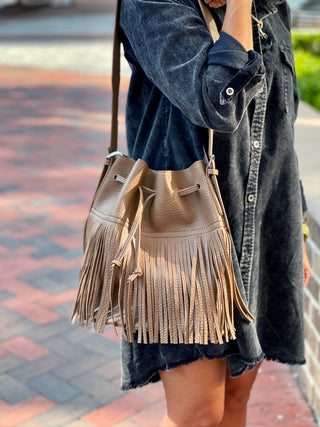 a taupe boho style fringed shoulder bag with adjustable strap