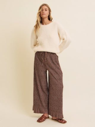 fluffy long sleeve cream sweater worn with baggy printed trousers