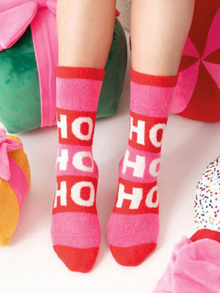 fuzzy striped red and pink holiday socks that say hohoho