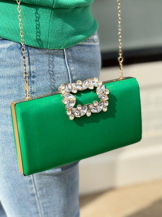 a sleek green metallic box clutch purse with a silver rhinestoned clasp and gold shoulder chain