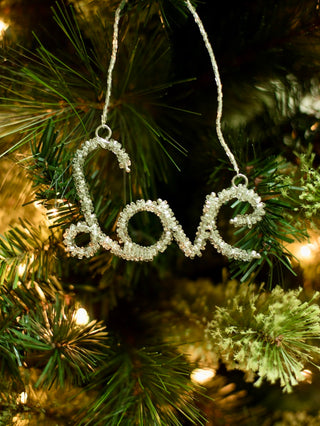 decorate your christmas tree with a cursive beaded word ornament in green that reads love for holiday home decor