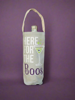 a canvas halloween themed wine bag that reads here for the boos perfect for spooky season gifts