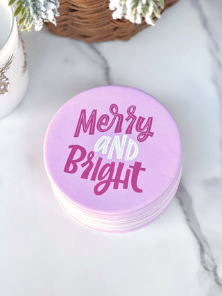 fun pink coasters that say merry and bright