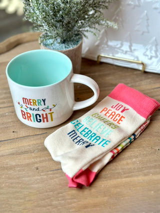 a merry and bright holiday coffee mug and sock gift set