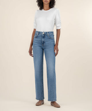 ivory scoop neck shirt with shirred sleeves paired with blue straight leg jeans 