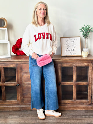 fun and comfortable vintage high rise wide leg denim jeans worn with a white sweatshirt