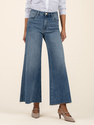 a pair of high rise wide leg denim jeans with a raw hem