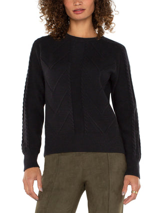 black cable knit sweater with long raglan sleeves