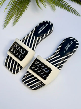 sleek black and white striped sandals with a padded heel and think strap