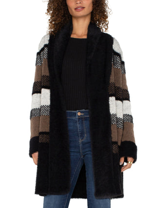 a soft faux fur cardigan in a striped black and tan design