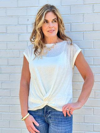 a soft lightweight short sleeve white top with a flirty front twist detail