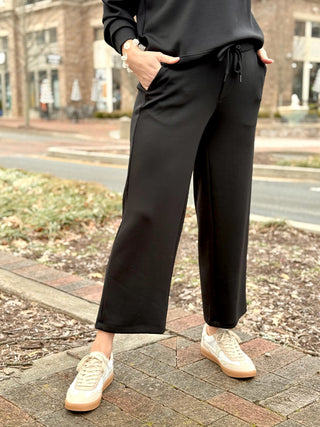 a pair of black soft drawstring cropped pants