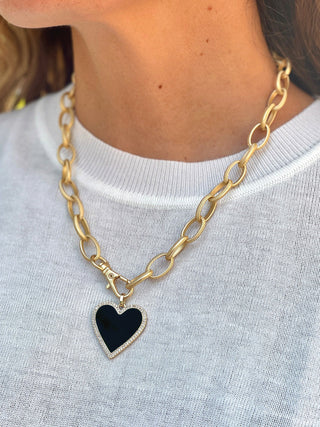 a large gold link chain necklace with front lobster clasp and black heart pendant