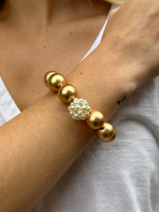 a chunky matte gold and pearl stretch bracelet